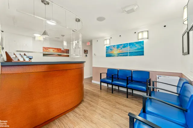 a wooden bench sitting in backside of a house with large trees
