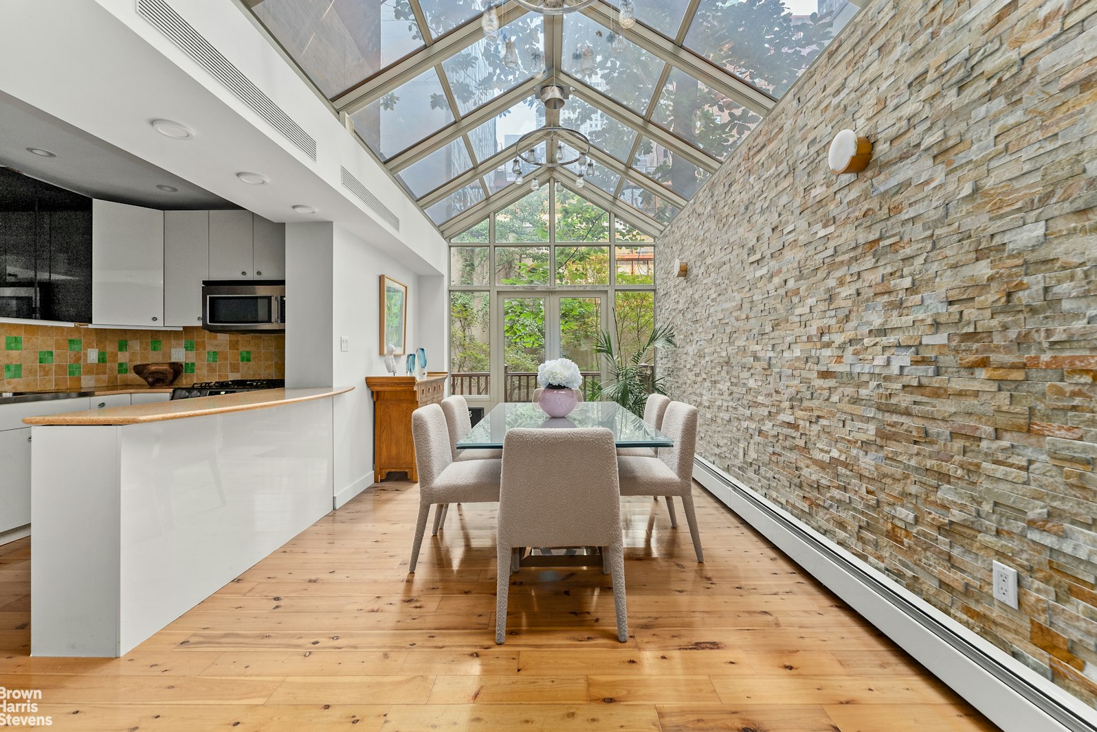 131 East 38th Street Manhattan, NY 10016 - Photo 4 of 26 a view of a dining room with furniture a chandelier and wooden floor