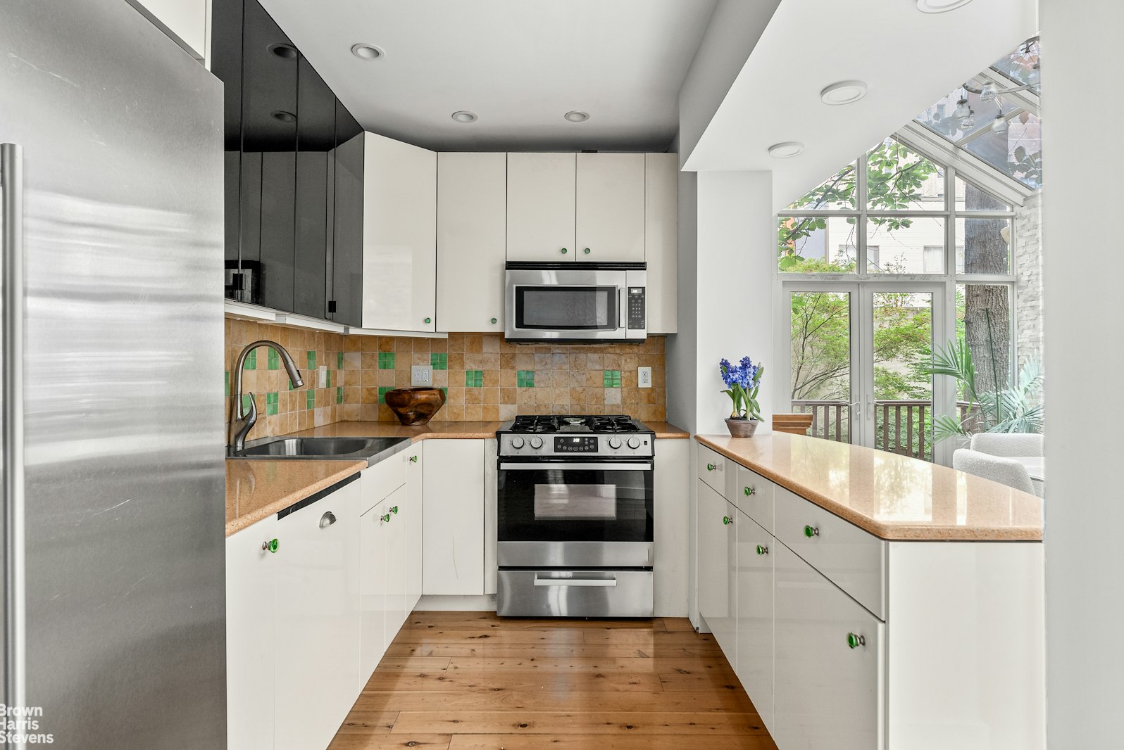 131 East 38th Street Manhattan, NY 10016 - Photo 5 of 26 a kitchen with granite countertop a stove and a sink