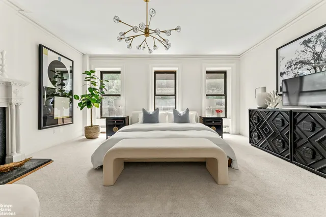 a spacious bedroom with a bed and a fireplace