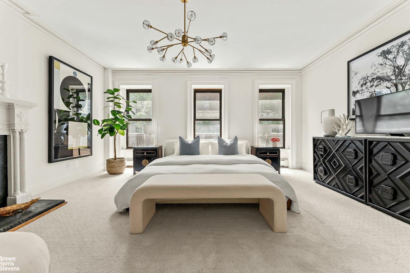 131 East 38th Street Manhattan, NY 10016 - Photo 8 of 26 a spacious bedroom with a bed a couch and dresser