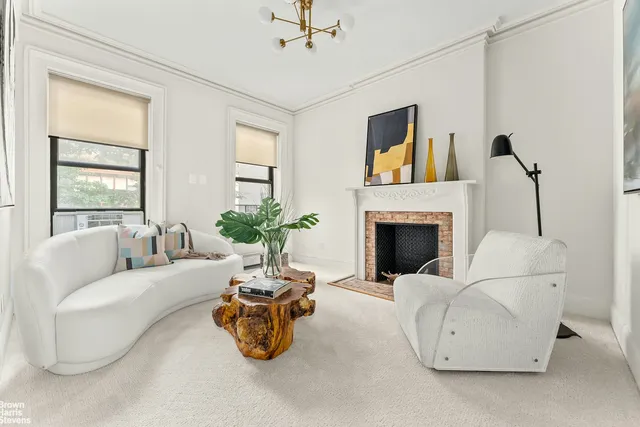 a spacious bedroom with a bed a couch and dresser