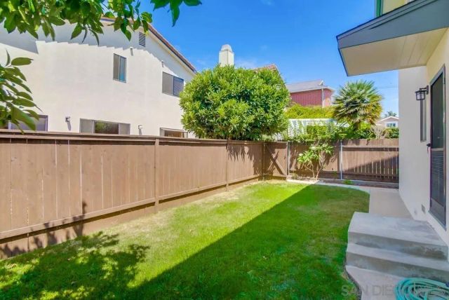 a view of yard with small huts and green space