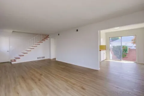 a room with a wooden floor and a large window