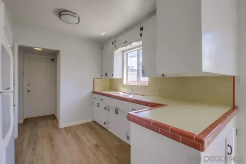 a kitchen with a sink stove and refrigerator