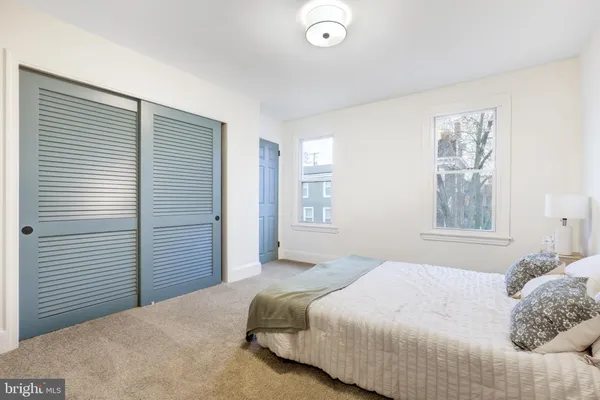 a bedroom with a large bed and a window