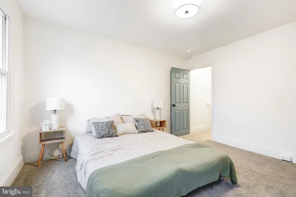 a bedroom with a bed and a night stand