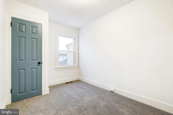 an empty room with windows and closet