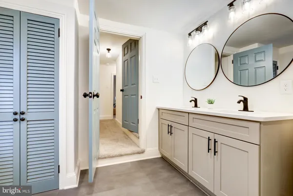 a bathroom with a double vanity sink and a mirror