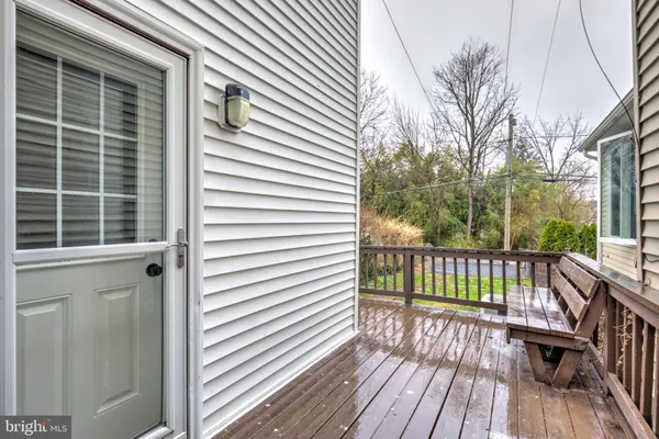 a view of balcony with wooden floor and fence