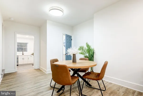 a dining room with furniture and wooden floor