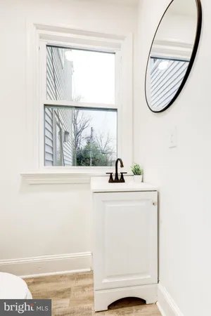 a bathroom with a window and a sink