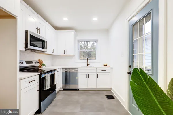 a kitchen with a sink stove and cabinets