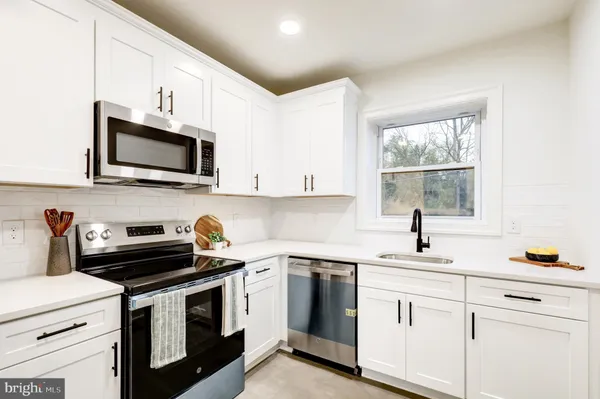 a kitchen with a sink stove and microwave