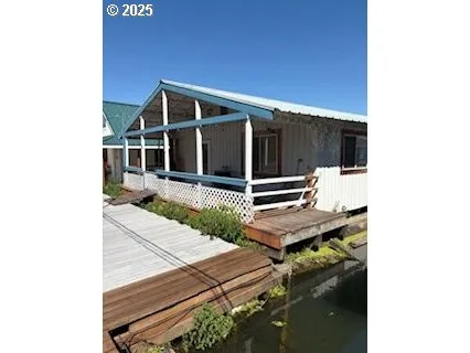 a backyard of a house with table and chairs
