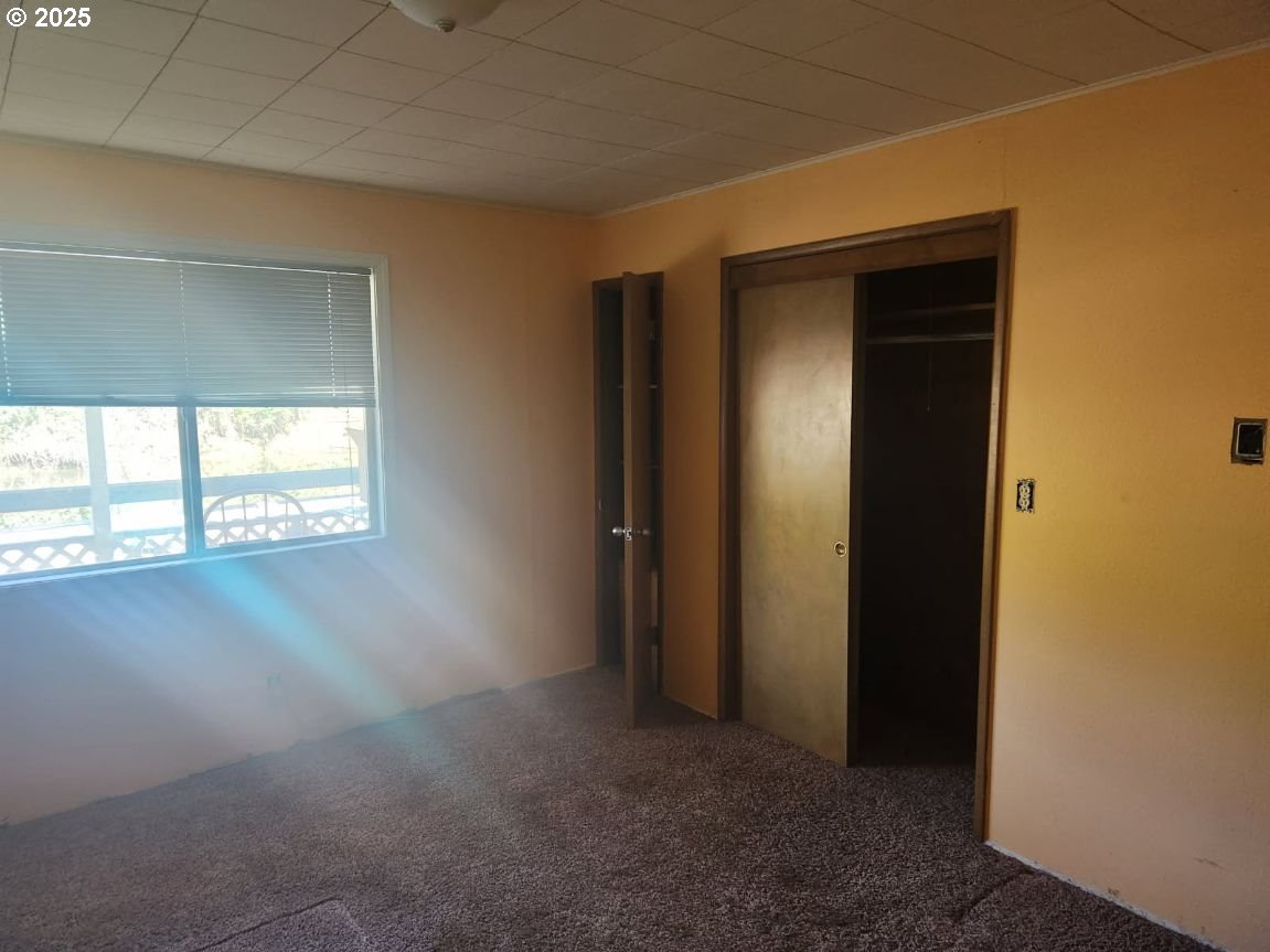 50350 Cowens Road, Unit 8 Scappoose, OR 97056 - Photo 8 of 8 an empty room with windows