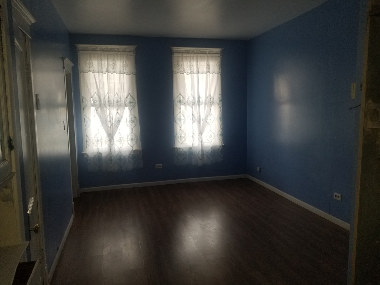 2453 West 46th Place, Unit 1 Chicago, IL 60632 - Photo 3 of 14 an empty room with wooden floor and windows