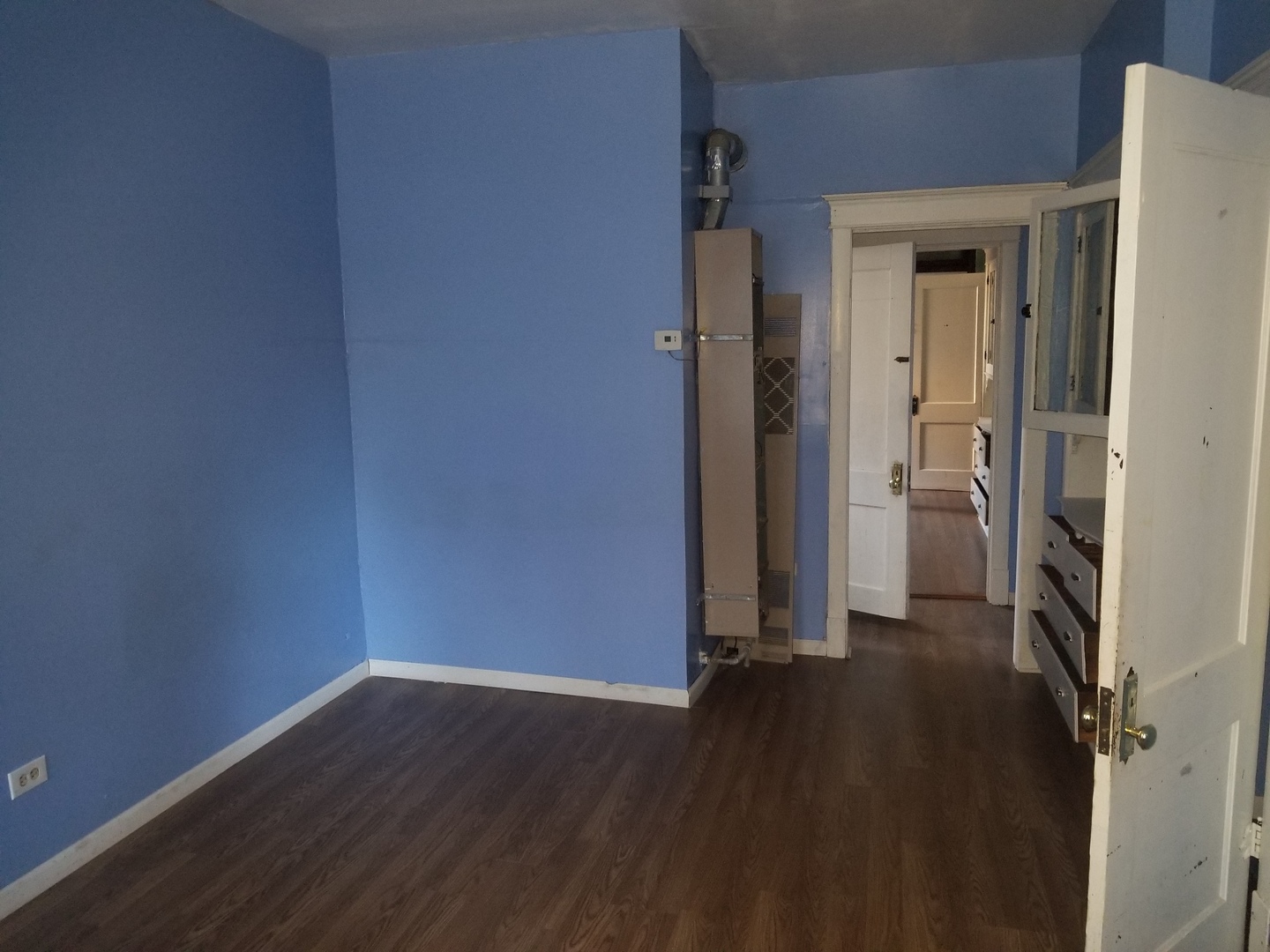 2453 West 46th Place, Unit 1 Chicago, IL 60632 - Photo 5 of 14 an empty room with wooden floor and a window