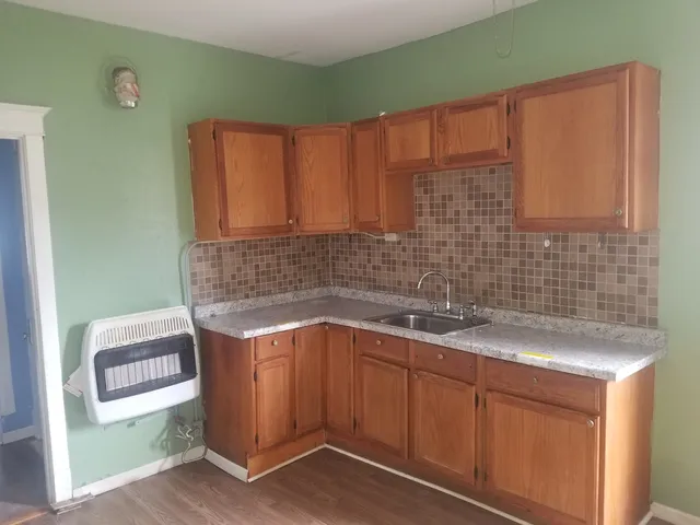 a kitchen with a sink cabinets and window