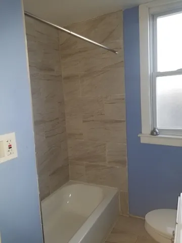 a bathroom with a shower and toilet