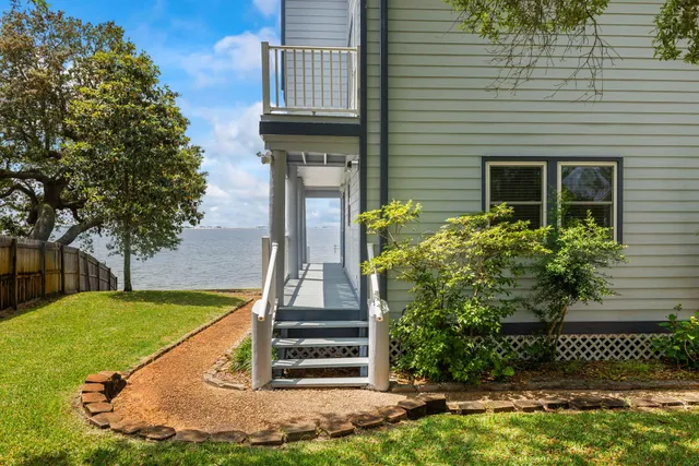 a kitchen with a sink a stove a refrigerator and a dining table with wooden floor