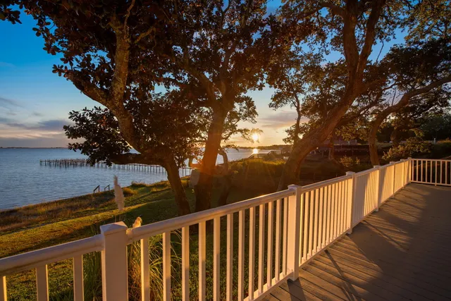 a balcony with wooden fence and trees