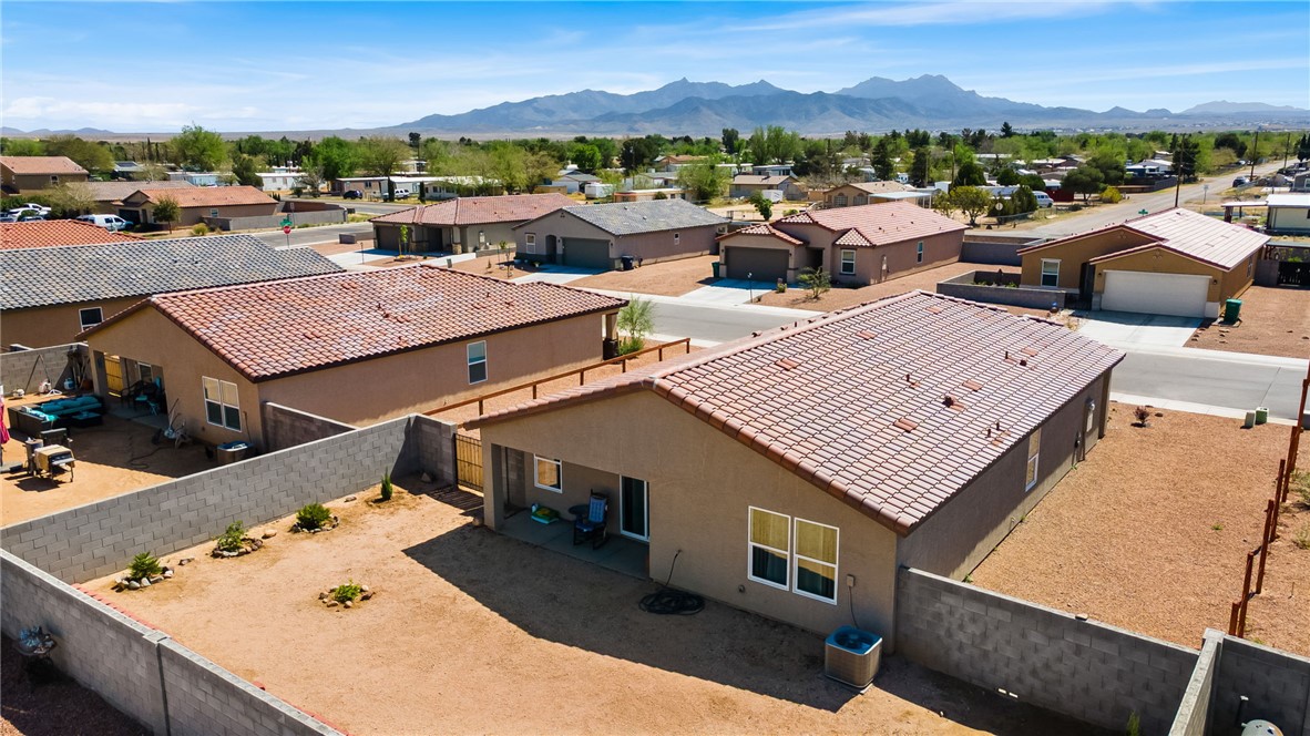 3623 East Andrea Drive Kingman, AZ 86409 - Photo 33 of 40 The property features a tile roof, a private fenced yard, and a patio area