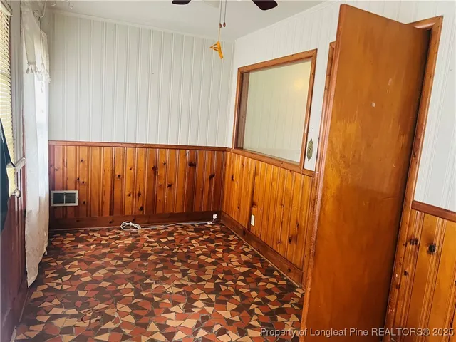 a view of a closet with wooden floor