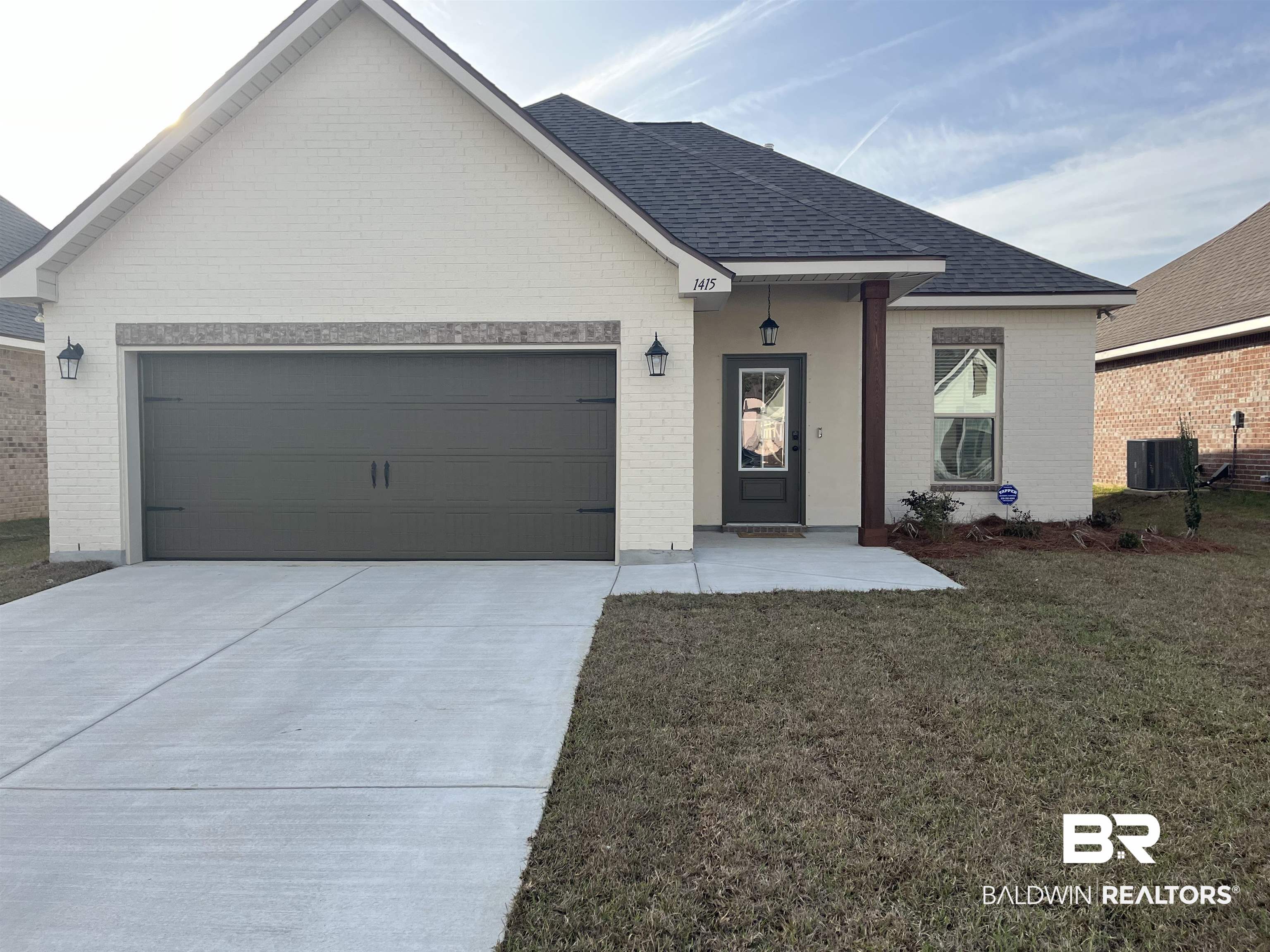 1415 Fenton Circle Foley, AL 36535 - Photo 1 of 3 Ranch-style home with central AC, a garage, and a front lawn