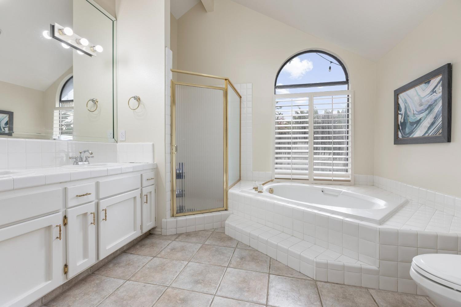 2128 Swift Avenue Clovis, CA 93611 - Photo 15 of 25 a spacious bathroom with a double vanity sink mirror and bathtub