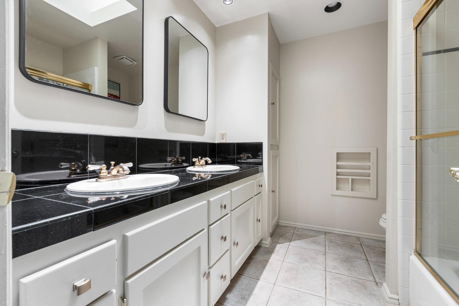 2128 Swift Avenue Clovis, CA 93611 - Photo 16 of 25 a bathroom with a sink and a mirror