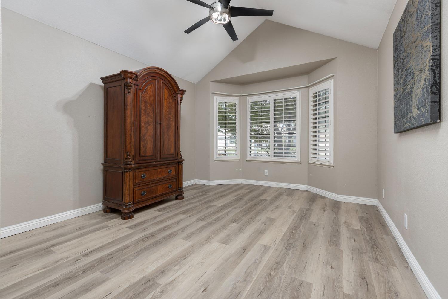 2128 Swift Avenue Clovis, CA 93611 - Photo 17 of 25 a view of a livingroom with wooden floor and a ceiling fan