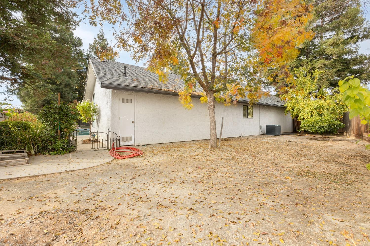 2128 Swift Avenue Clovis, CA 93611 - Photo 24 of 25 a backyard of a house with a large tree