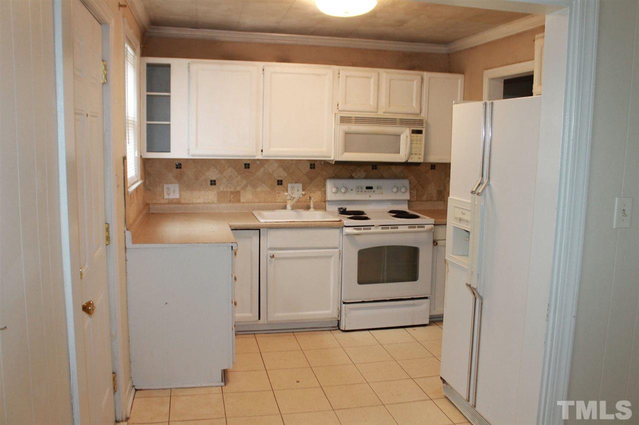 425 Colleton Road Raleigh, NC 27610 - Photo 3 of 5 a kitchen with white cabinets and white appliances