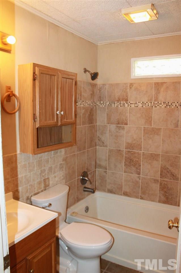 425 Colleton Road Raleigh, NC 27610 - Photo 4 of 5 a bathroom with a sink a toilet and shower