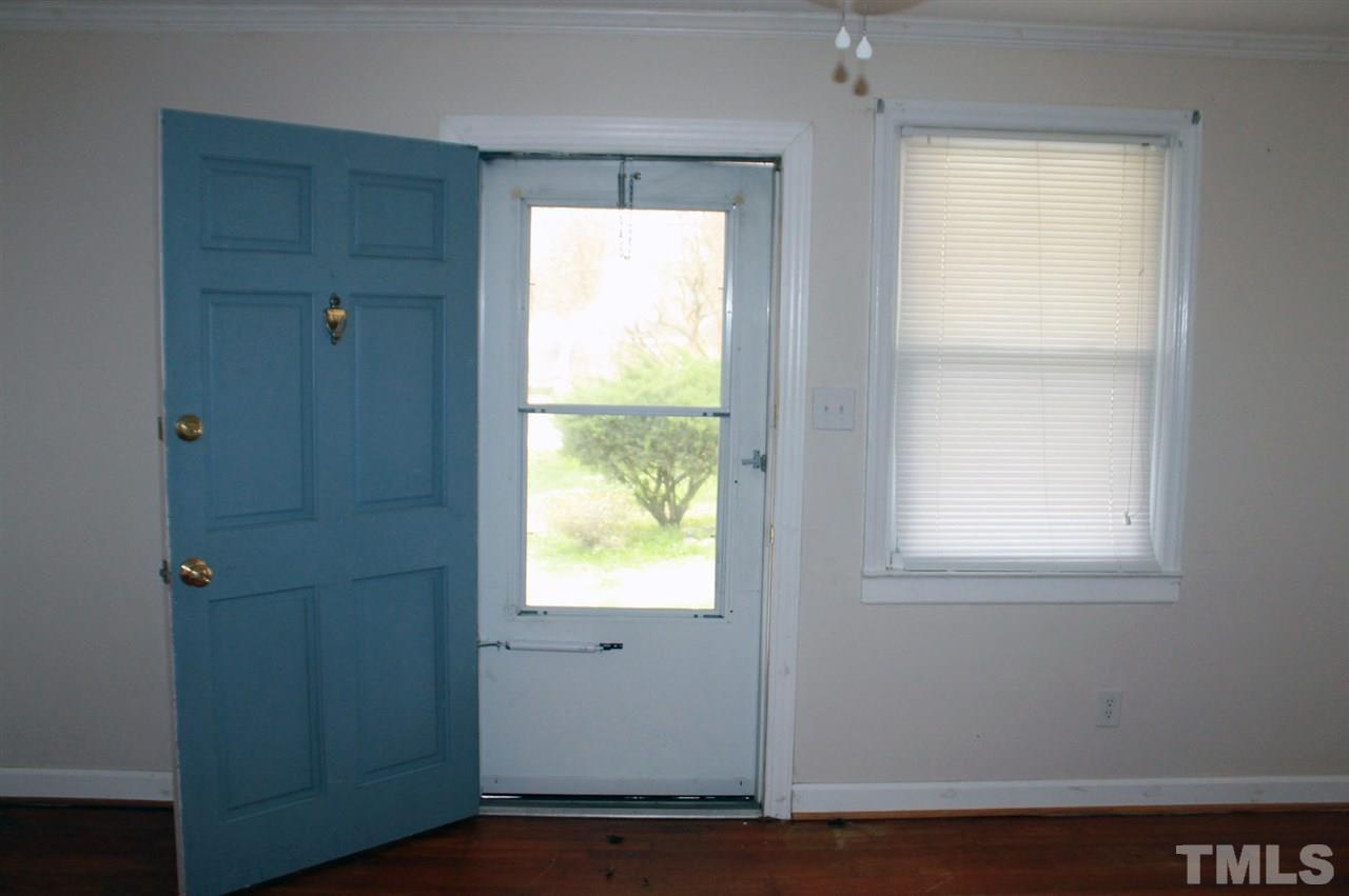425 Colleton Road Raleigh, NC 27610 - Photo 5 of 5 a view of an empty room with wooden floor and a window