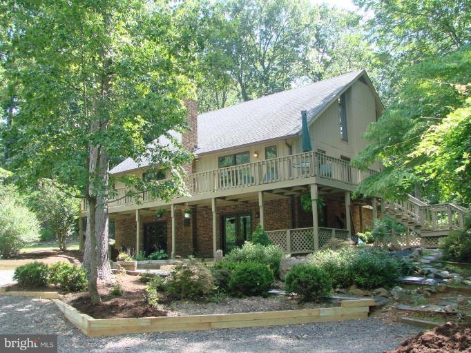 6711 Carters Run Road Marshall, VA 20115 - Photo 1 of 16 a front view of a house with a yard and potted plants