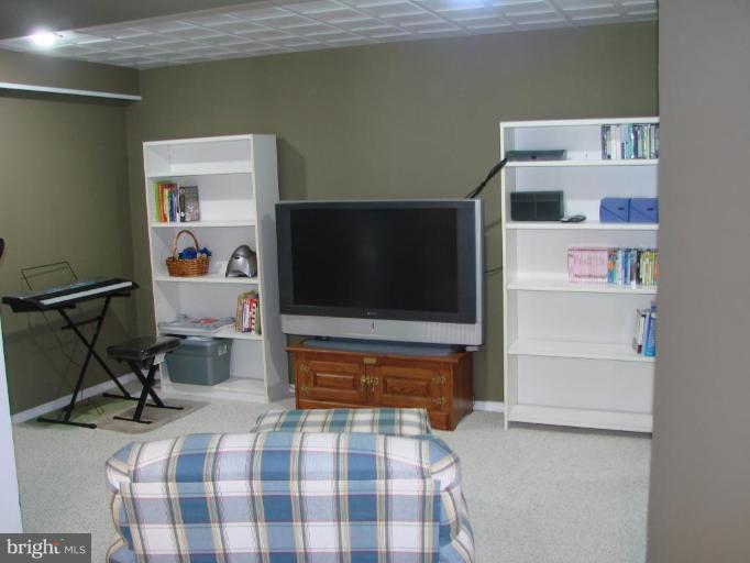 6711 Carters Run Road Marshall, VA 20115 - Photo 14 of 16 a bedroom with a bed and a flat screen tv