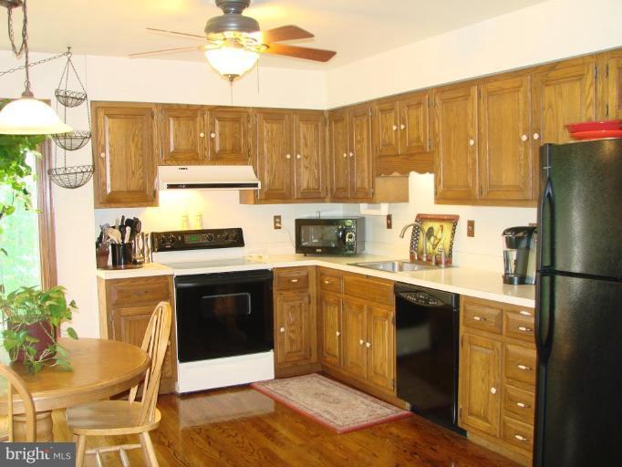 6711 Carters Run Road Marshall, VA 20115 - Photo 10 of 16 a kitchen with a refrigerator and a stove top oven