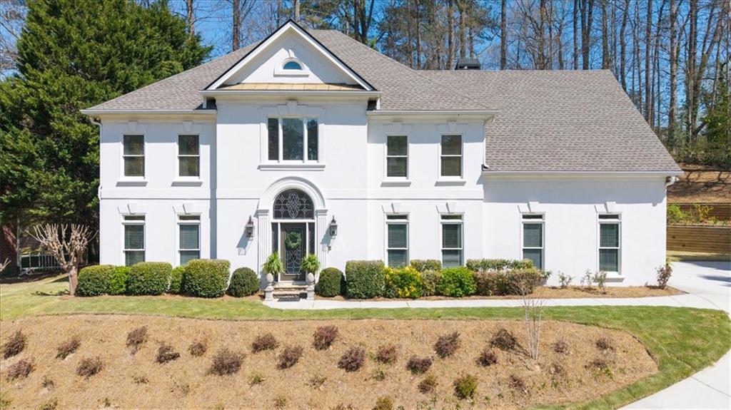 a front view of a house with garden