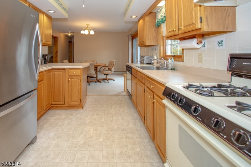 171 Mt Salem Road Wantage, NJ 07461 - Photo 11 of 38 a kitchen with stainless steel appliances granite countertop a stove a sink dishwasher and a refrigerator
