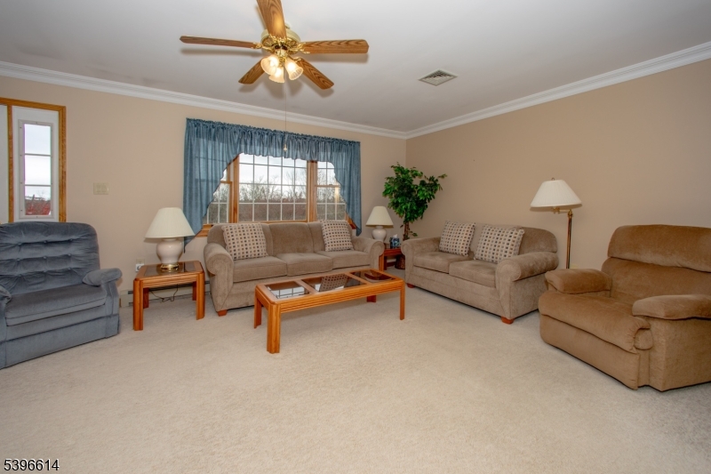 171 Mt Salem Road Wantage, NJ 07461 - Photo 5 of 38 a living room with furniture and a chandelier