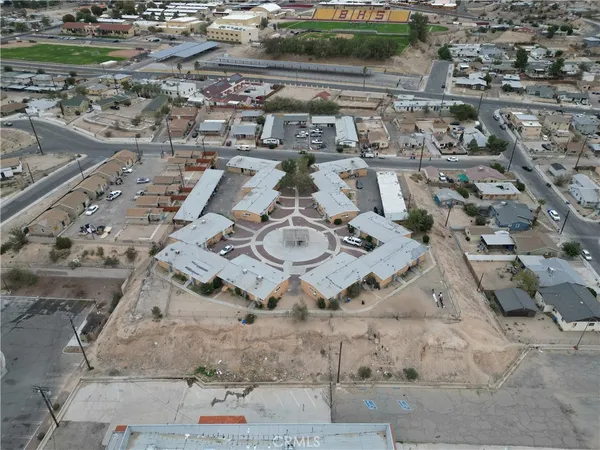 an aerial view of a house with a yard