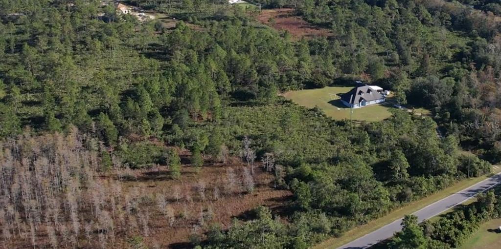 640 Sheldon Street Orlando, FL 32833 - Photo 3 of 4 a backyard of a house with a yard and outdoor seating
