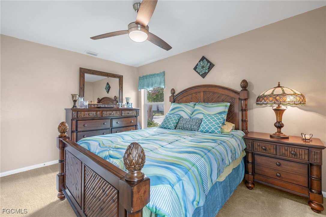11545 Cinnamon Cove Boulevard Fort Myers, FL 33908 - Photo 21 of 26 a bedroom with a bed and dresser