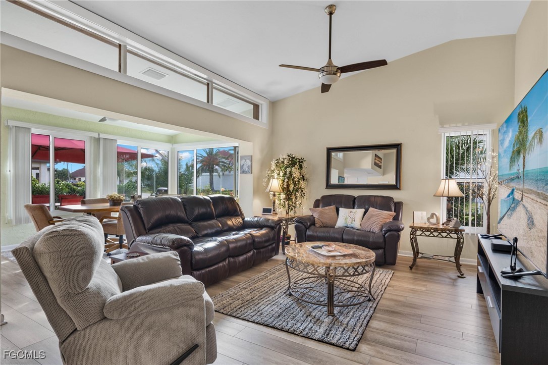 11545 Cinnamon Cove Boulevard Fort Myers, FL 33908 - Photo 5 of 26 a living room with furniture a flat screen tv and a floor to ceiling window