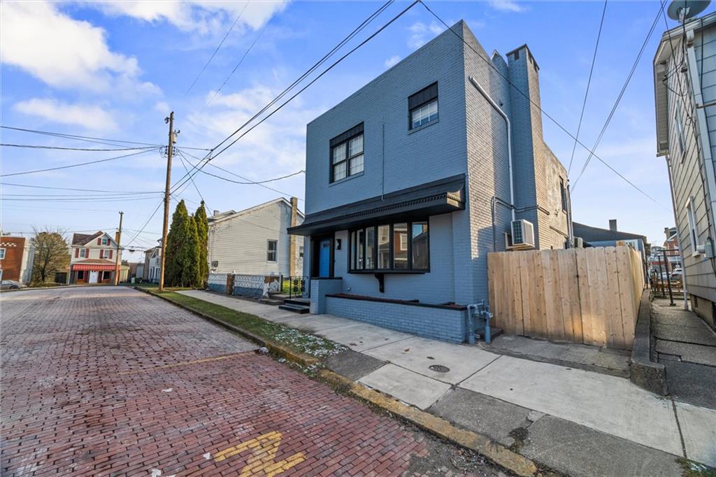 a street sign on a sidewalk next to a road
