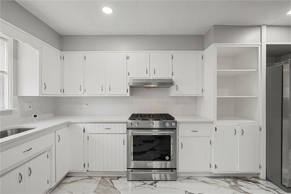 309 Beech Street Vandergrift, PA 15690 - Photo 11 of 47 a kitchen with white cabinets and appliances