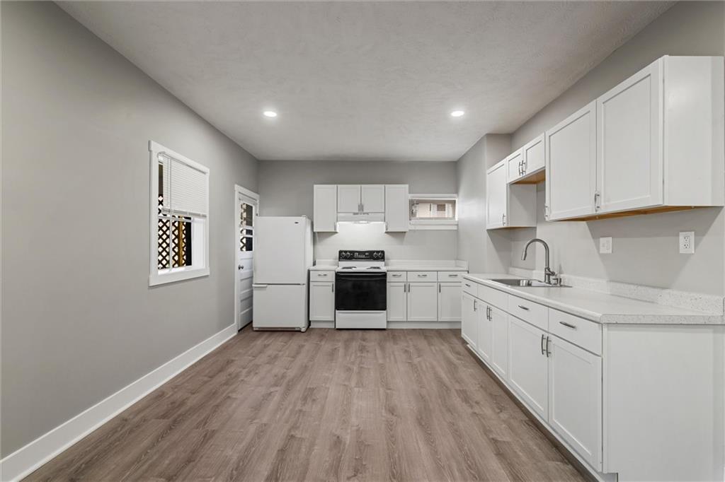 309 Beech Street Vandergrift, PA 15690 - Photo 34 of 47 a kitchen with granite countertop white cabinets and white appliances