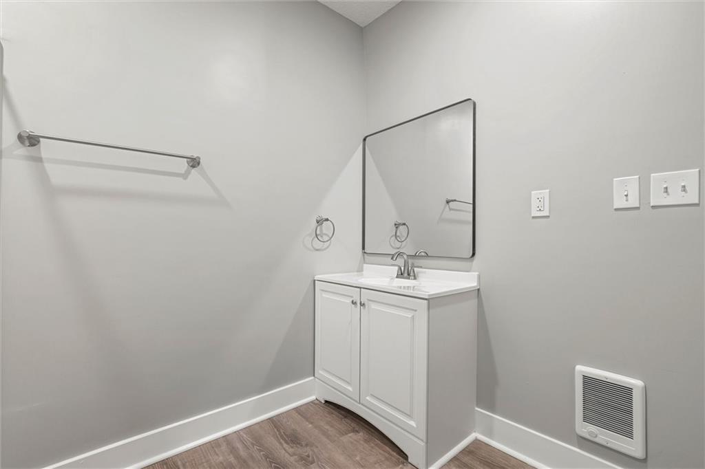 309 Beech Street Vandergrift, PA 15690 - Photo 39 of 47 a bathroom with a sink a mirror and vanity